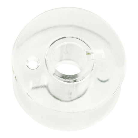 Clear Janome bobbin showing its flange and central opening.